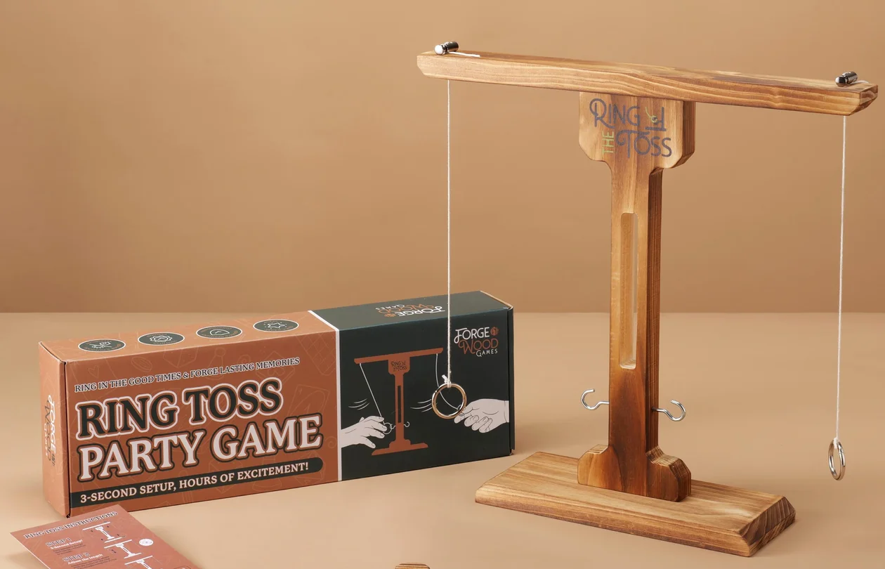 Forgewood Dark Wood ring toss game with its actual product packaging in a warm studio setting